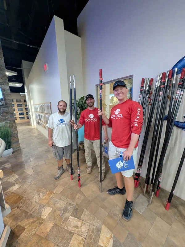 Love Pool Care team members in branded shirts with cleaning equipment