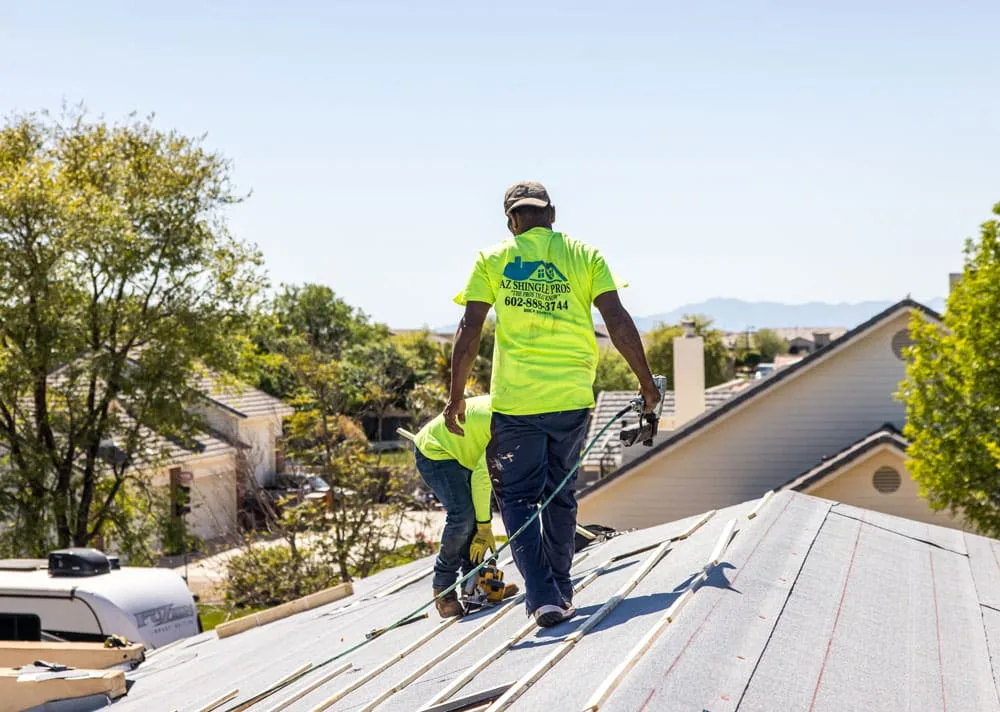 An AZ Shingle Pros crew repairing storm-damaged shingles in Phoenix